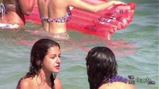 Two Italian girls playing under the water on the topless beach